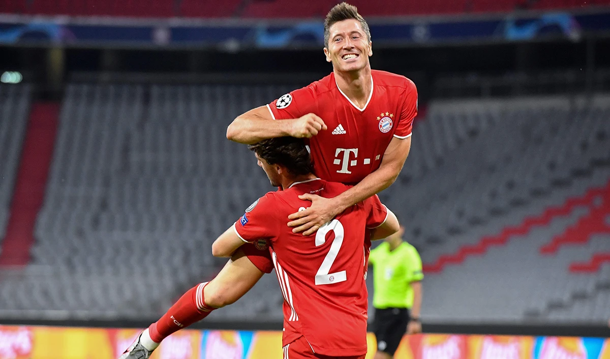 Bayern Munich forward Robert Lewandowski (up) celebrates with his teammate Alvaro Odriozola after scoring his team’s fourth goal during the Champions League round of 16 second leg match against Chelsea. (AFP)