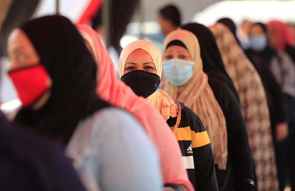 Egyptians wearing face masks against Covid-19 queue up to vote on August 11, 2020 for a new senate in an upper house election. The two-day vote for 200 of the Senate’s 300 seats will be largely contested by candidates who back President Abdel Fattah El-Sisi, who has quietened most opposition within and outside the legislature. (AFP)