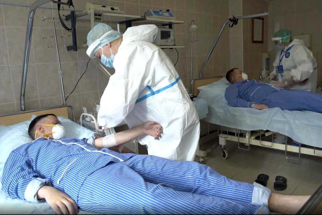 In this photo made from footage provided by the Russian Defense Ministry on Wednesday, July 15, 2020, medical workers in protective gear prepare to draw blood from volunteers participating in a trial of a coronavirus vaccine at the Budenko Main Military Hospital outside Moscow, Russia. (AP)