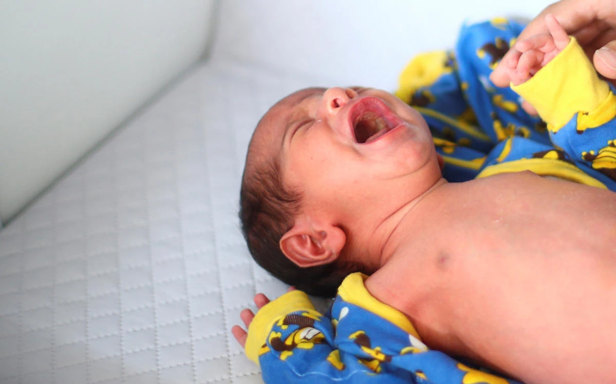 George Khnaisser, whose mother was in labour at the moment of the Beirut port blast, lies on a changing table at the family home in Jal el-Dib, Lebanon, August 12, 2020. (Reuters)