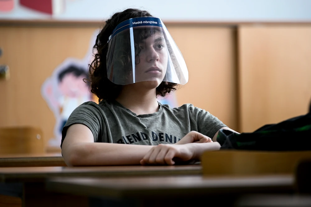 A student wearing a 3D printed face shield and gloves attends a class at the "Faik Konica" primary school in Pristina on June 9, 2020. (AFP/File Photo)
