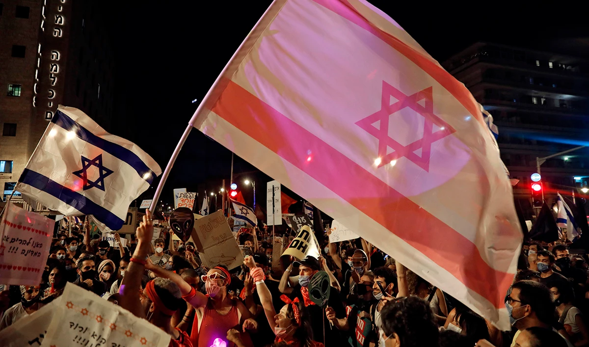Protesters gather with Israeli flags during a demonstration against the Israeli government near the Prime Minister's residence in Jerusalem. (AFP)