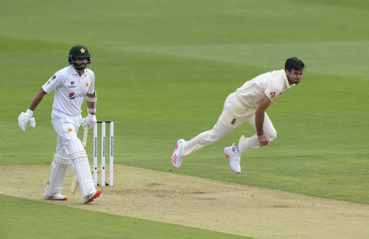 England's James Anderson, right, bowls past Pakistan's captain Azhar Ali during the first day of the second cricket Test match between England and Pakistan, at the Ageas Bowl in Southampton, England, Thursday, Aug. 13, 2020. (AP)