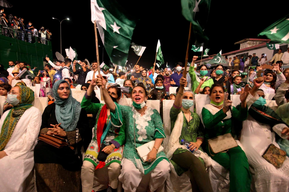 People cheer while watching fireworks during the Independence Day celebrations, in Karachi, Pakistan, Friday, Aug. 14, 2020. (AP Photo/Fareed Khan)