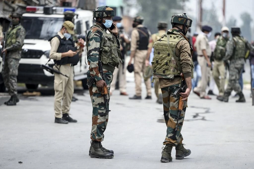 Security personnel stand guard near the site where suspected militants fired at police near Nowgam bypass in Srinagar on August 14, 2020. (AFP)