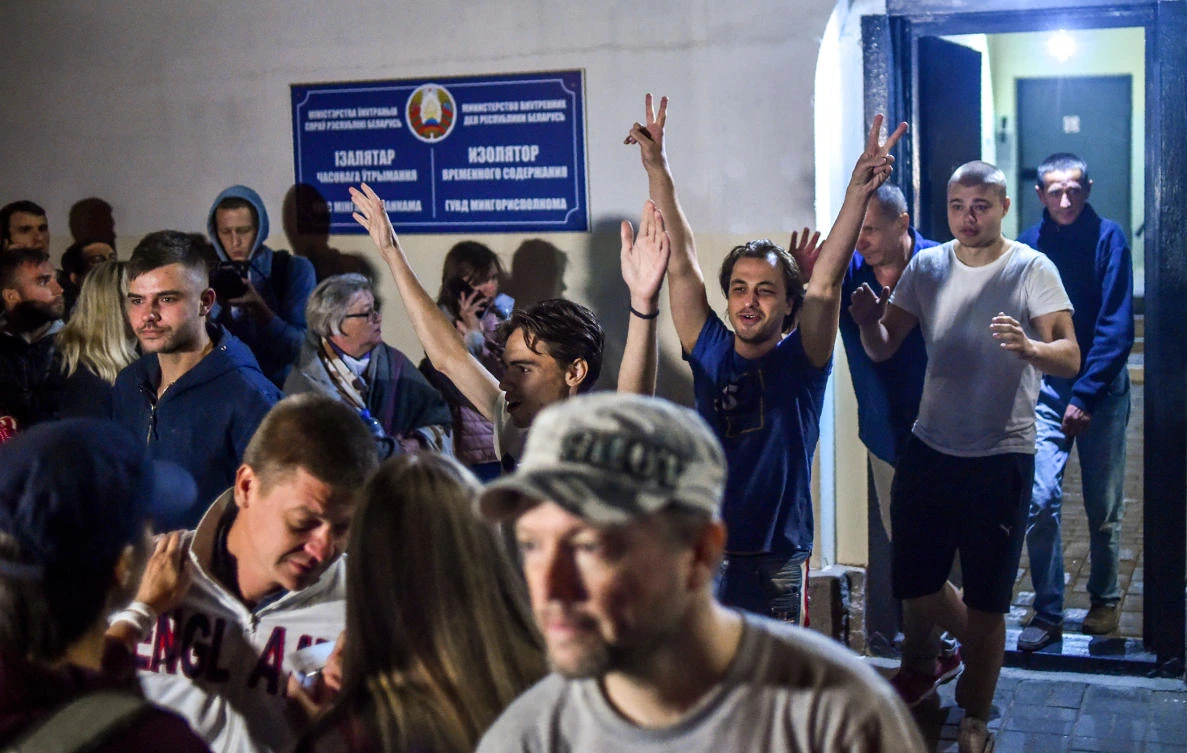 People detained during recent rallies of opposition supporters, who accuse strongman Alexander Lukashenko of falsifying the polls in the presidential election, leave the Okrestina prison early morning in Minsk on Aug. 14, 2020. (Sergei Gapon/AFP)