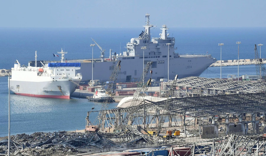 This picture shows a view of Beirut's port in the aftermath of a huge chemical explosion that disfigured the Lebanese capital, on August 14, 2020 with French Navy amphibious assault helicopter carrier Tonnerre while moored at it. (AFP)