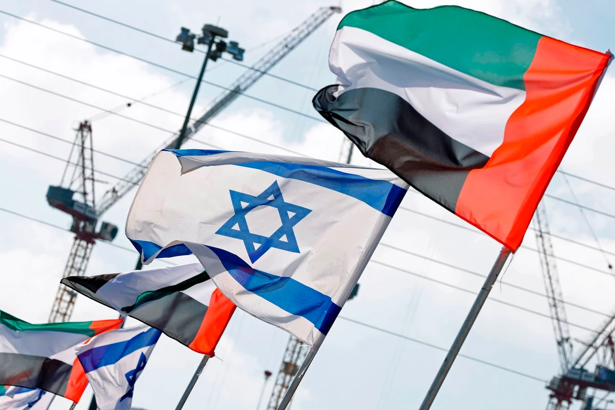 Israeli and UAE flags line a road in the Israeli coastal city of Netanya, on August 16, 2020. (AFP)