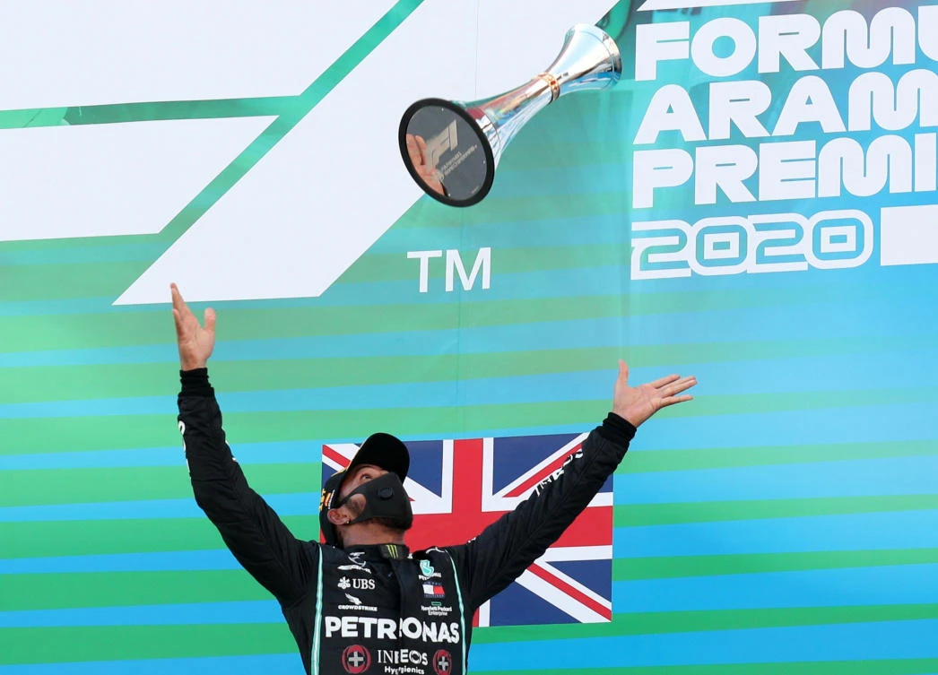 Winner Mercedes' Lewis Hamilton celebrates on the podium Pool. (Reuters)