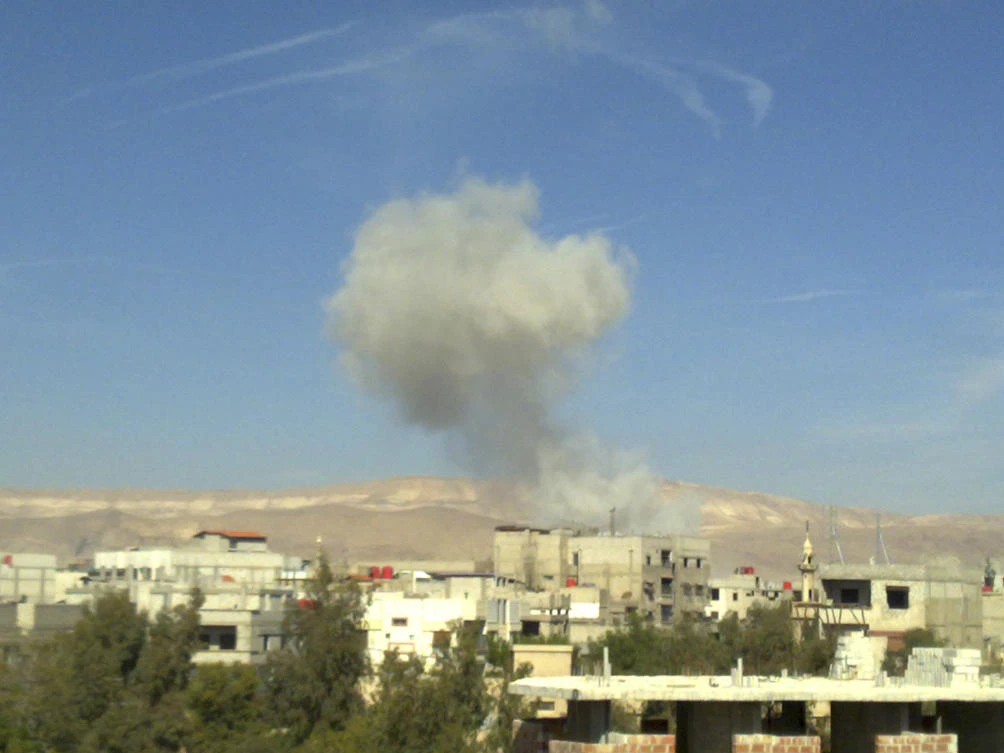Smoke rises from what activists say was a missile fired by a Syrian Air Force fighter jet loyal to Syria's President Bashar al-Assad at Erbeen, near Damascus. (File/Reuters)