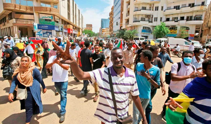 Sudanese protesters shout slogans outside the Council of Ministers in the heart of Khartoum. Around 3,000 people marched on Monday shouting ‘justice, justice.’ (AFP)