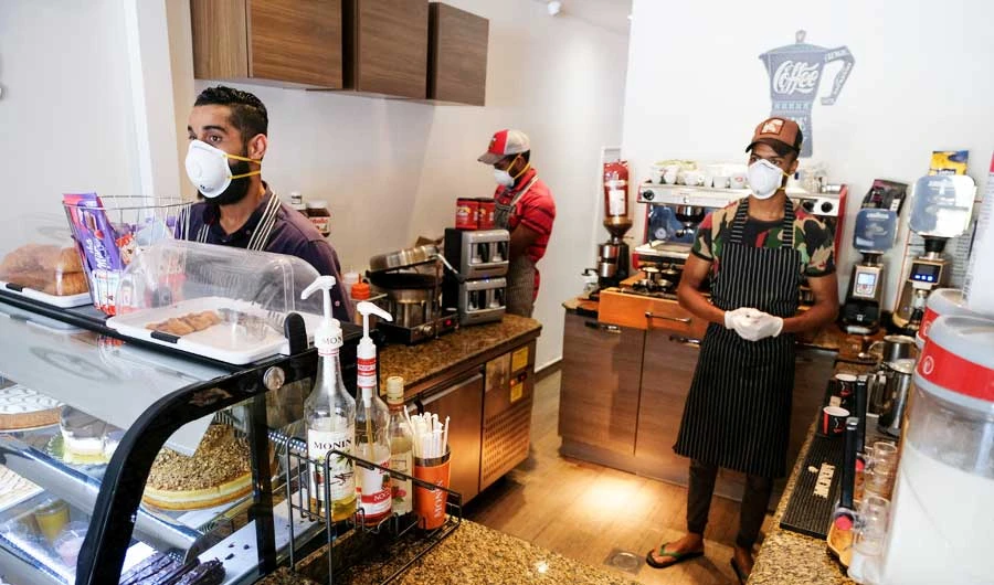 Workers wear protective face masks as they are seen in a cafe shop following the outbreak of the coronavirus disease (COVID-19), in Benghazi. (Reuters)