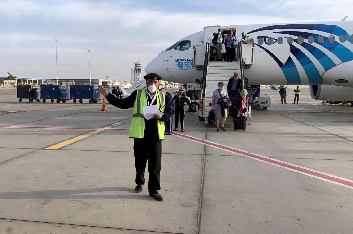 Passengers, some of them wearing protective masks, following an outbreak of the coronavirus disease (COVID-19), arrive at Luxor International Airport, Egypt March 9, 2020. (Reuters)