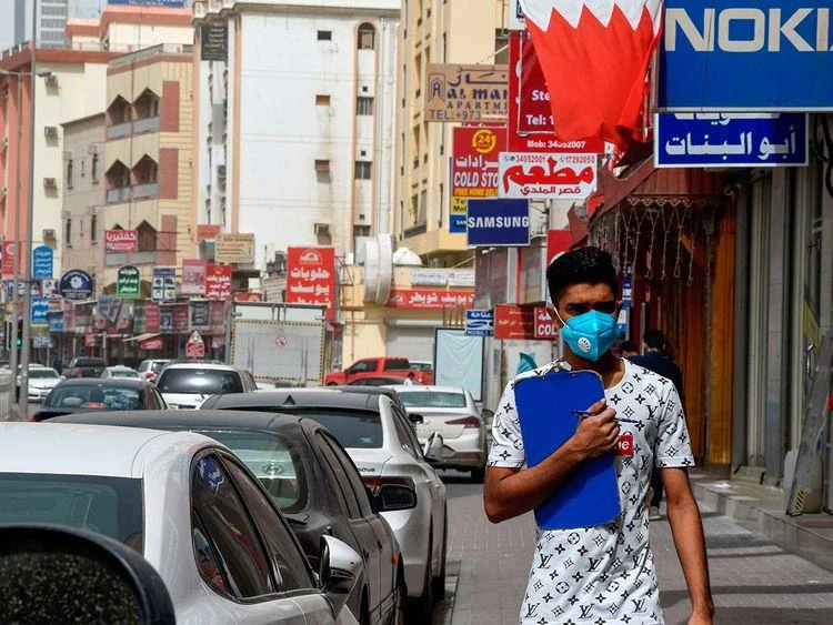 A man wearing a surgical mask in the center of the Bahraini capital Manama, February 26, 2020. (AFP)