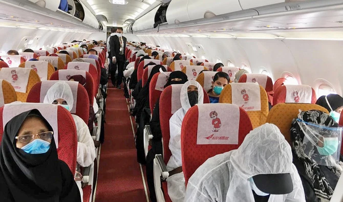 A handout picture provided by the Embassy of India in Riyadh on May 8, 2020 shows Indian expats inside a plane upon their departure at King Fahad International airport heading to Kozhikode. (AFP)