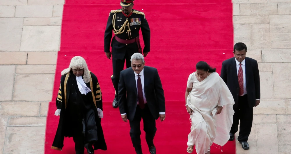 Sri Lanka's President Gotabaya Rajapaksa, First lLady Ioma Rajapaksa and Speaker Mahinda Yapa Abeywardena arrive at parliament to present the new government's policy statement. (Reuters)