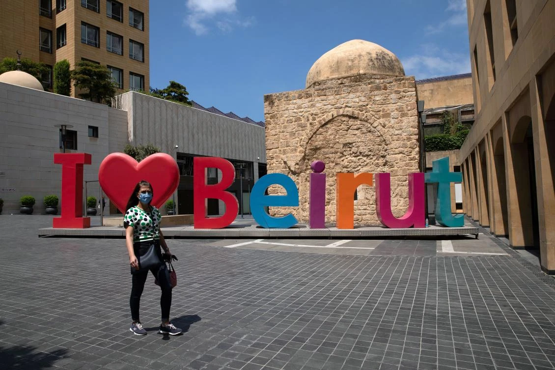 A woman wearing a face mask walks past an “I love Beirut” sign, near a shopping district, as Lebanon imposed a partial lockdown for two weeks starting on Friday in an effort to counter the spread of the coronavirus disease (COVID-19), which have spiralled since the catastrophic explosion at Beirut port, Lebanon August 21, 2020. (Reuters/Alkis Konstantinidis)