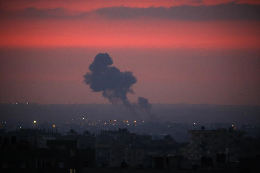Smoke rises in the distance after war planes belonging to the Israeli army carried out airstrikes over Khan Yunis, in the Southern Gaza Strip early morning on August 21, 2020. (AFP)