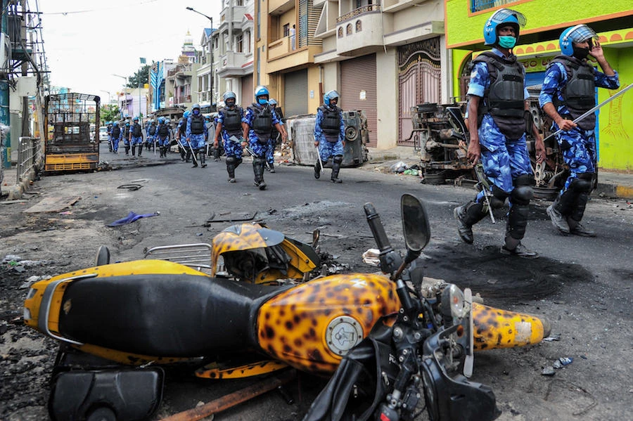 Rapid Action Force (RAF) personnel patrol on a street of Devara Jevana Halli in Bangalore on August 13, 2020, after a "derogatory" Facebook post about the Prophet Mohammed sparked riots. (File/AFP)