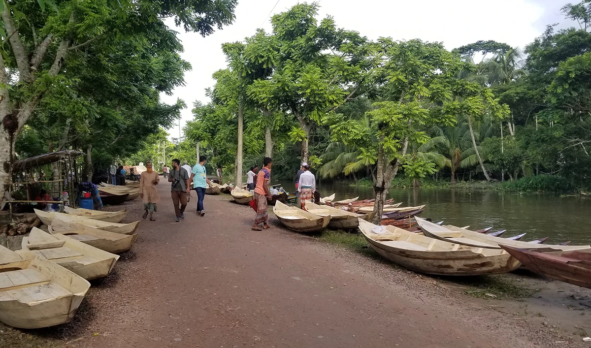 Several boats line a 100-year-old traditional market which is held every Friday in Bangladesh's southern district of Pirojpur. Located along the banks of the Sandhya river in Atghar, Pirojpur, the market caters to the demand of thousands of residents in the region. (AN Photo by Shehab Sumon)