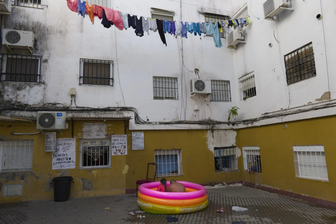 Two people sit in a plastic pool in Seville, Spain on Aug. 19, 2020. Isabel says that “it is terrible as we have to live but my son has Down syndrome and he has a Covid 10 risk profile so we can’t go to the public pool.” (AP/Laura Leon)