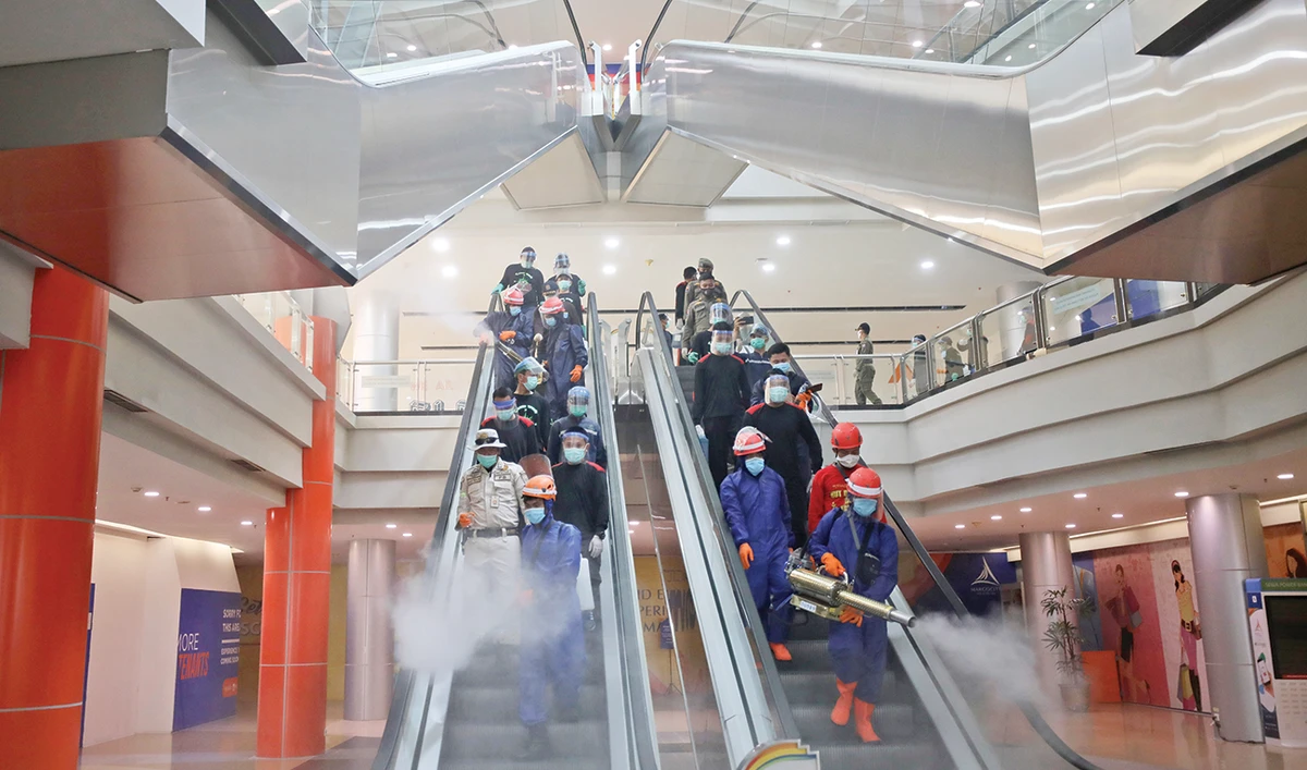 Indonesian firemen at work to help curb the spread of the new coronavirus outbreak at Margo City shopping mall, which was closed to the public, in Depok, Indonesia. (AP)