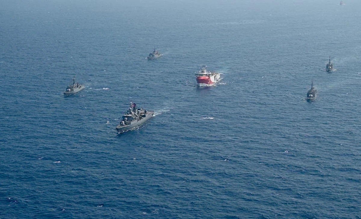 Turkey’s research vessel, Oruc Reis, center, is surrounded by Turkish naval vessels in the eastern Mediterranean, Aug. 10, 2020. (AP Photo)
