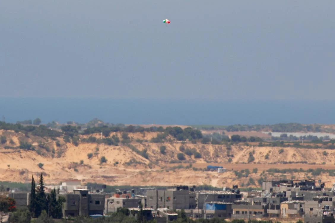Balloons carrying incendiary devices launched from the Gaza Strip fly over the southern Israeli Kibbutz Nir Am near the border with the Gaza Strip, on August 24, 2020. (File/AFP)