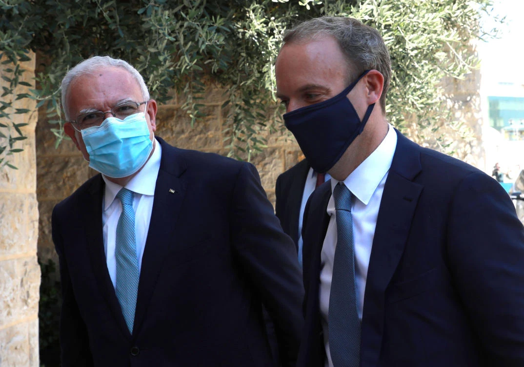 British Foreign Secretary Dominic Raab (L) and his Palestinian counterpart Riyad al-Malki arrive for a meeting with the Palestinian prime minister in the West Bank City of Ramallah on August 25, 2020. (AFP)