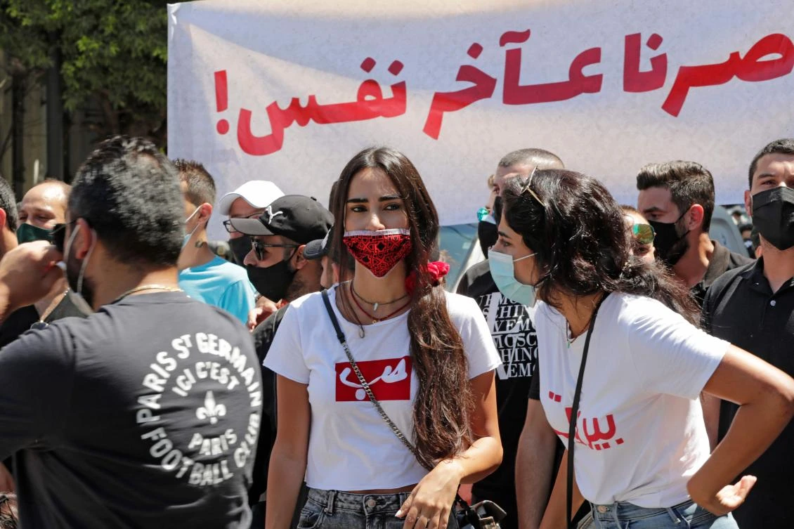 Lebanese demonstrators wearing protective masks take part in a rally called for by the Lebanese Federation for Tourism Industries in downtown Beirut on August 25, 2020, to protest the government's lack of support for the sector and its workforce. (AFP)