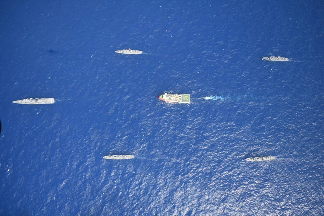Turkey's research vessel, Oruc Reis, in red and white, surrounded by Turkish navy vessels as it was heading in the west of Antalya on the Mediterranean. (AP)