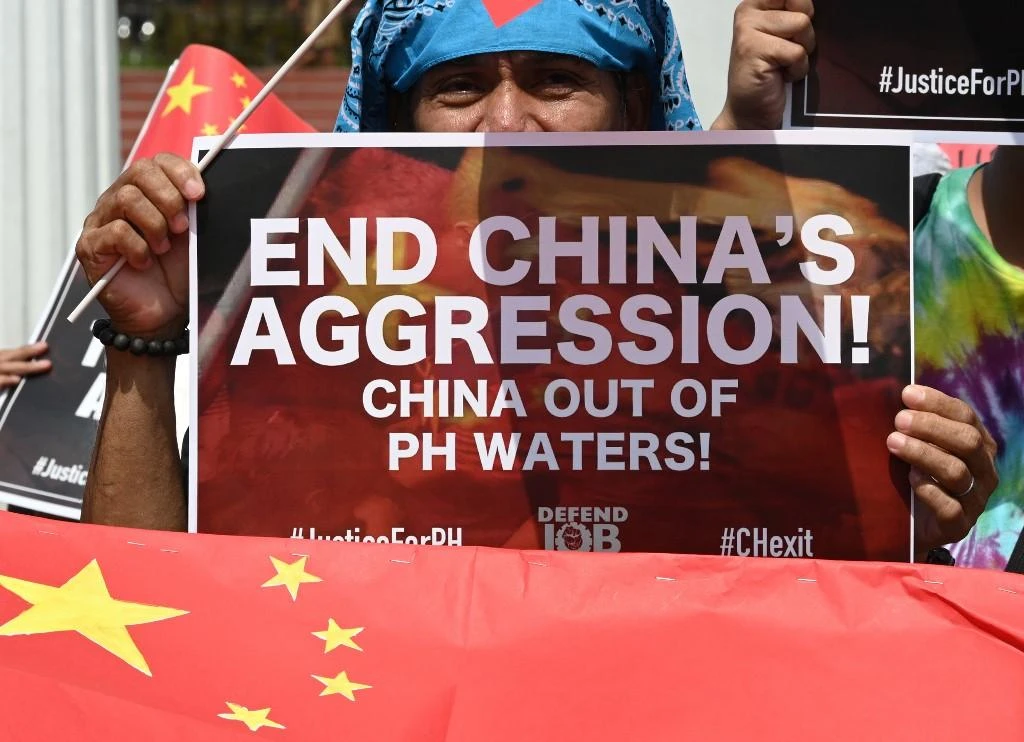 Activists display placards and flags during a protest in Manila against Beijing’s presence in South China Sea in this June 18, 2019 photo. (AFP)