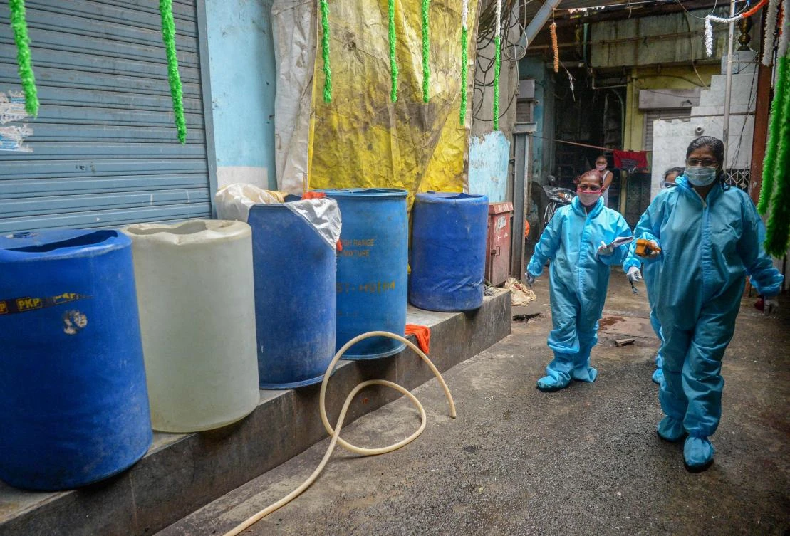 Health workers wearing Personal Protective Equipments (PPE) walk inside the Dharavi slums during a door-to-door COVID-19 coronavirus screening in Mumbai on August 24, 2020. (AFP)