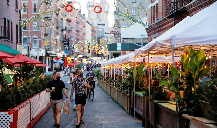 People walk by restaurant's outdoor patios after New York City Mayor Bill de Blasio announced 21 more locations for outdoor dining options as part of a city initiative that combines the Open Streets and Open Restaurants programs in place to fight the spread of the coronavirus disease (COVID-19) in Manhattan, New York City, U.S., August 14, 2020. (REUTERS)
