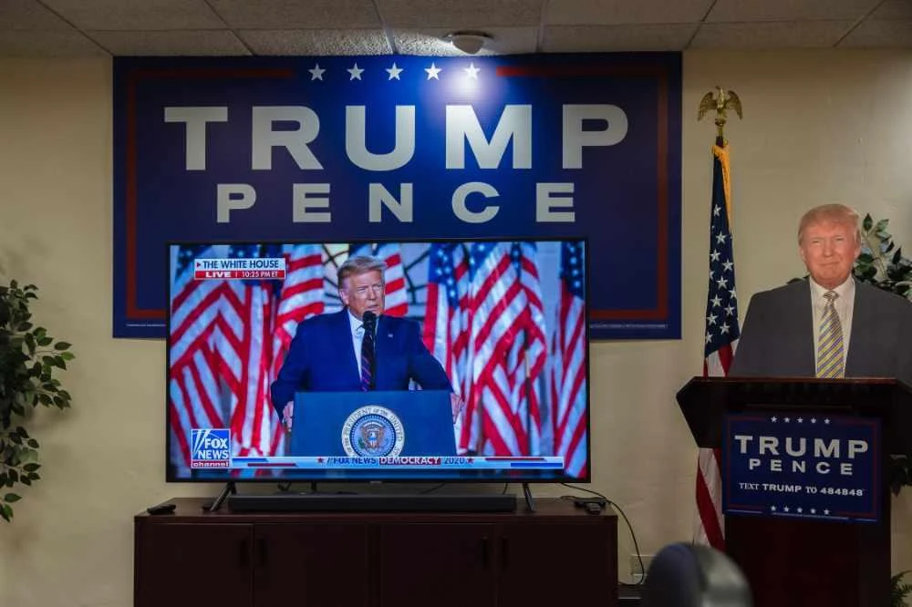 A cardboard cutout of US President Donald Trump stands next to the TV showing his acceptance speech for the Republican Party nomination for reelection during the final day of the Republican National Convention in the office of San Diego County's Republican Party in Rancho Bernardo, California on August 27, 2020. (AFP / ARIANA Drehsler)