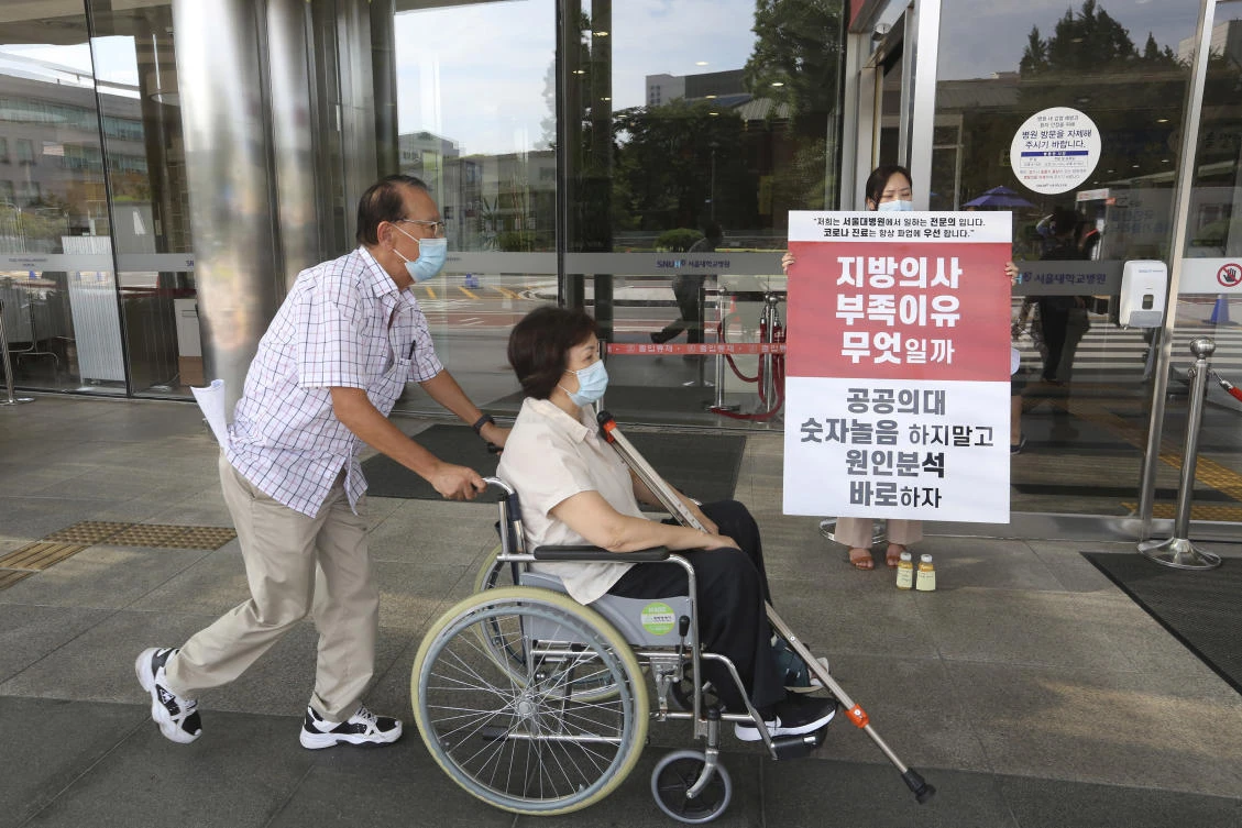 Above, a doctor holds a sign criticizing the government medical policy at the Seoul National University Hospital in Seoul, South Korea on Aug. 26, 2020. (AP)