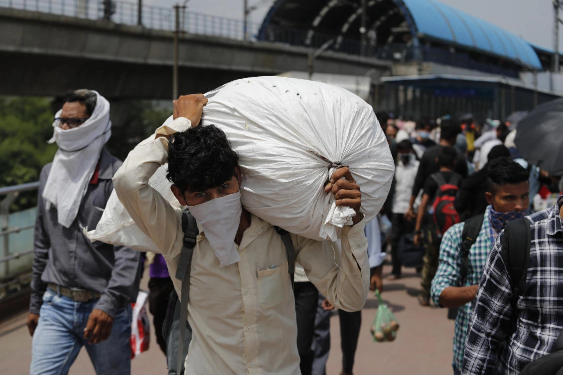 Above, a migrant laborer returns to the city for work in New Delhi, India. (AP)