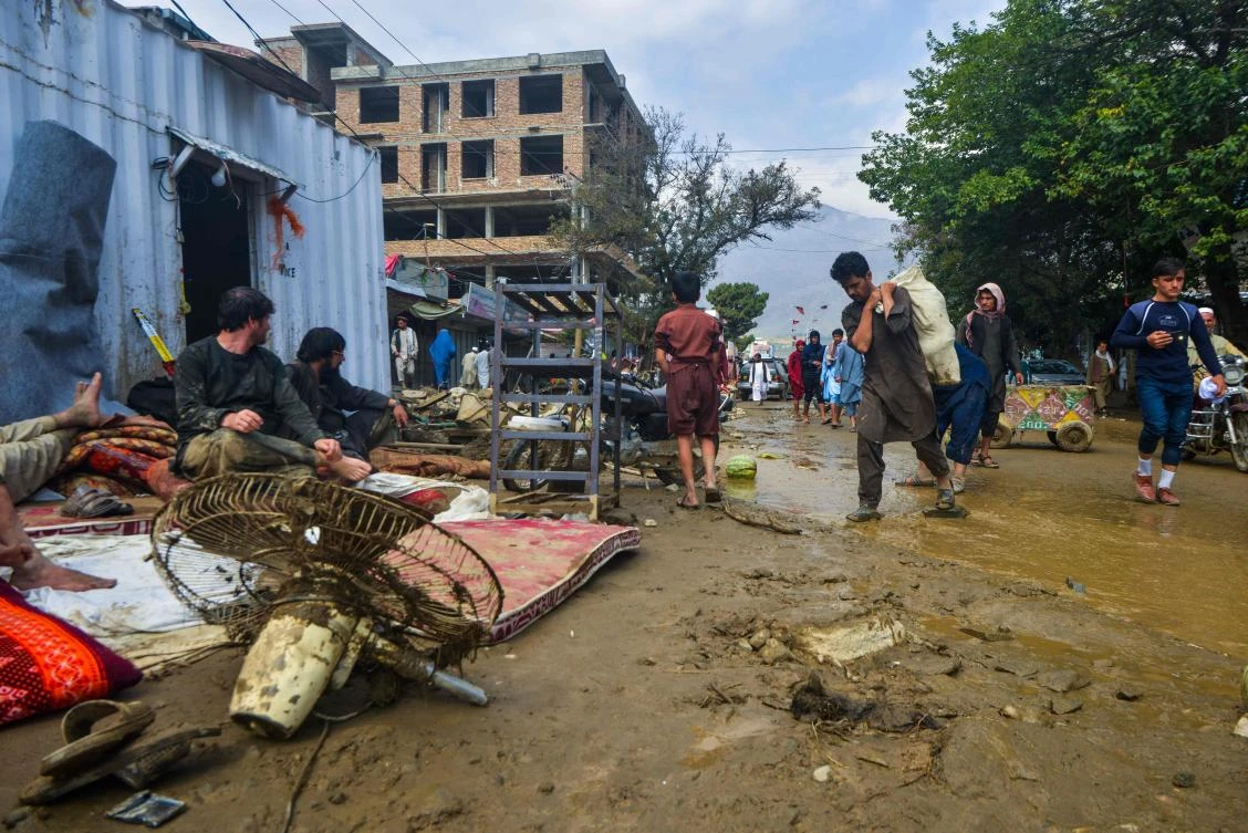 People go around a market area after a flash-flood in Charikar, Parwan province, on August 26, 2020. At least 46 people have been killed and hundreds of houses destroyed by flash floods as torrential rains lashed a city north of the Afghan capital, officials said on August 26. (AFP)