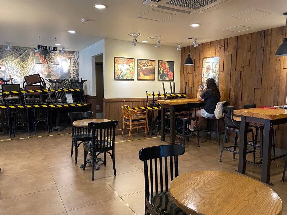 Tables and chairs are stacked up at a Starbucks café in downtown Seoul on Saturday in preparation for stricter social distancing rules which take effect on Monday. (AN Photo/Jeff Sung)