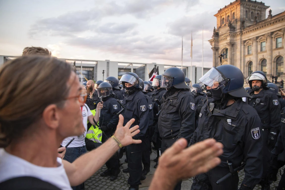 Police officers push away a crowd of demonstrators from the square 'Platz der Republik' in front of the Reichstag building during a demonstration against the Corona measures in Berlin, Germany, Saturday, Aug. 29, 2020. (AP)