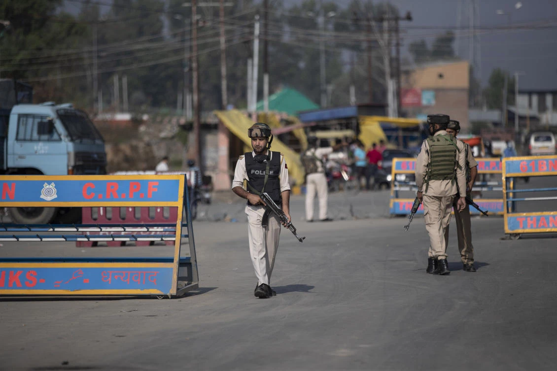 Indian police man a checkpoint near a gunbattle site on the outskirts of Srinagar, Indian controlled Kashmir on Sunday, Aug. 30, 2020. (AP)