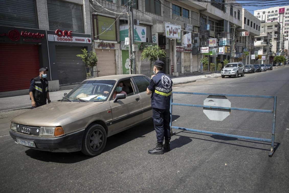 Palestinian Hamas policemen stop vehicles during a lockdown imposed following the discovery of coronavirus cases in the Gaza Strip, Thursday, Aug. 27, 2020. (AP)