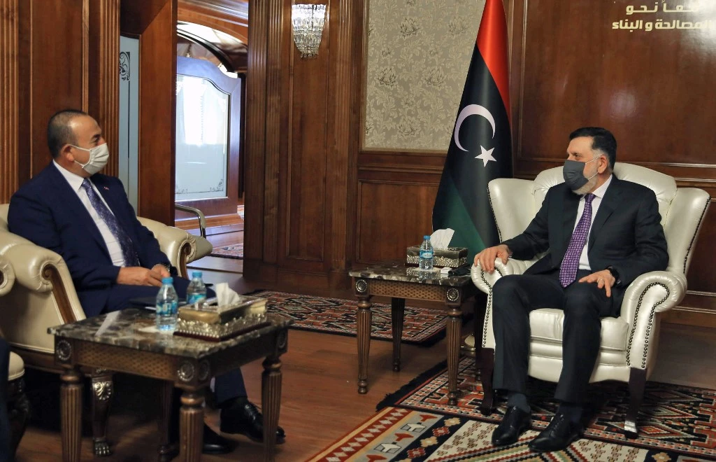 PM of Libya’s GNA Fayez Al-Sarraj (R) meets with Turkish Foreign Minister Mevlut Cavusoglu in the capital Tripoli, on August 6, 2020. (AFP)