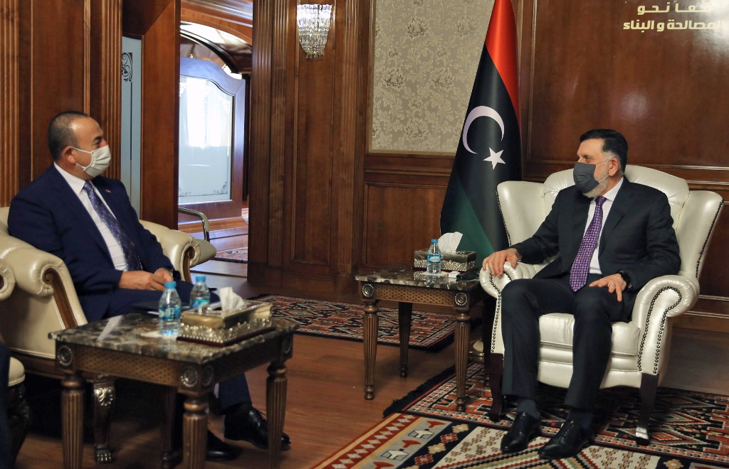 PM of Libya’s GNA Fayez Al-Sarraj (R) meets with Turkish Foreign Minister Mevlut Cavusoglu in the capital Tripoli, on August 6, 2020. (AFP)