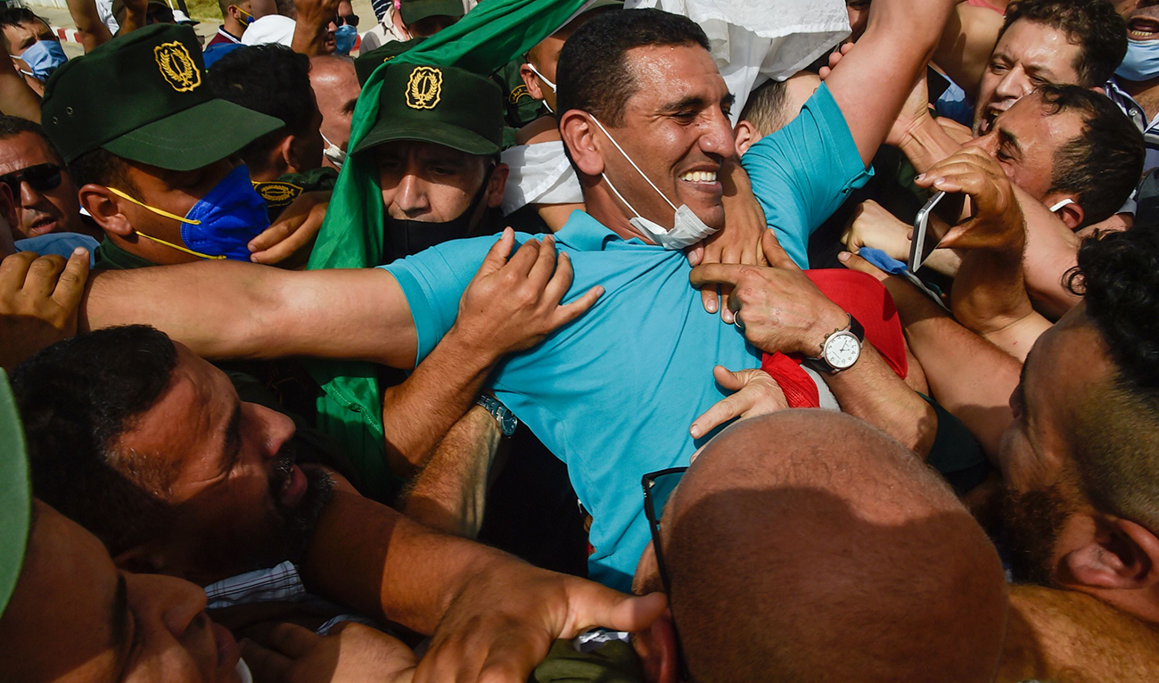 In this file photo taken on July 2, 2020 Karim Tabbou, one of the most prominent figures of "Hirak", gestures upon his release from prison. (AFP)
