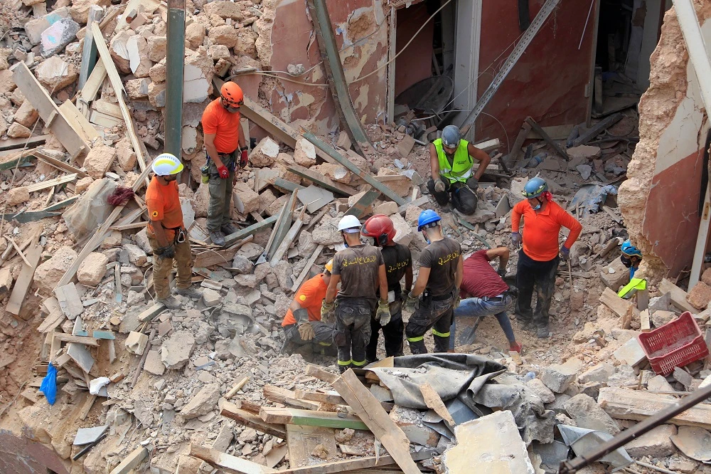 Rescuer workers dig through the rubble of a badly damaged Beirut building in search of possible survivors after scanners detected a pulse, early on September 4, 2020. (Reuters)