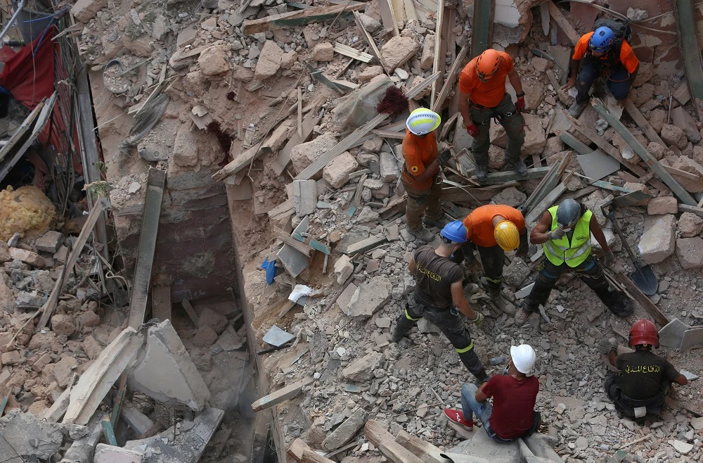 Rescuer workers dig through the rubble of a badly damaged Beirut building in search of possible survivors after scanners detected a pulse, early on September 4, 2020. (Reuters)