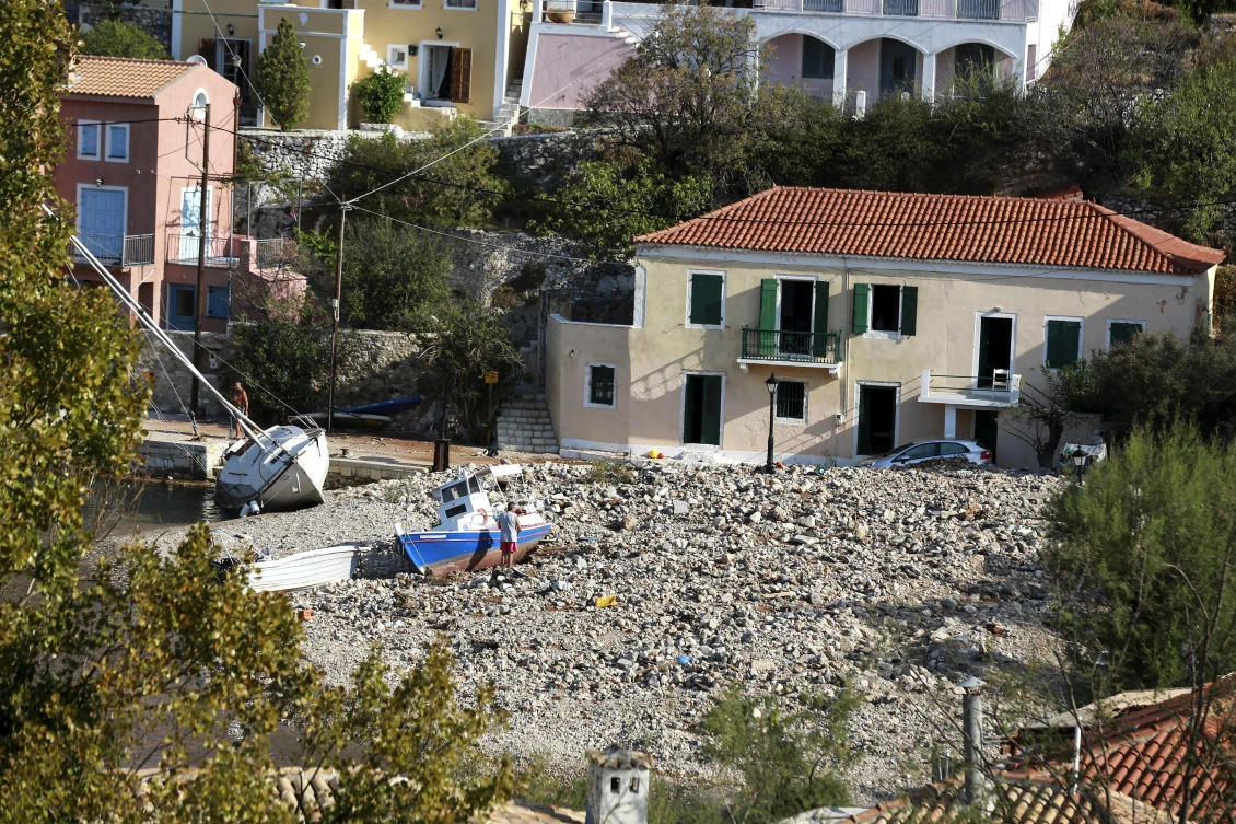Boats are seen on rocks at a beach following a storm at the village of Assos, on the Ionian island of Kefalonia, western Greece, Sunday, Sept. 20, 2020. A powerful tropical-like storm named Ianos, battered parts of central Greece and some of the western Ionian islands, as emergency workers rescued more than 600 people. (AP Photo/Nikiforos Stamenis)
