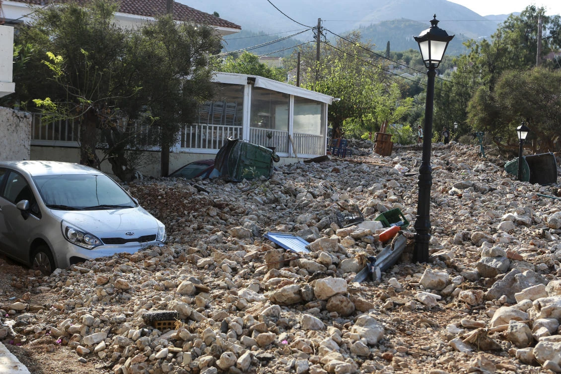 A street is covered with rocks following a storm at the village of Assos, on the Ionian island of Kefalonia, western Greece, Sunday, Sept. 20, 2020. A powerful tropical-like storm named Ianos, battered parts of central Greece and some of the western Ionian islands, as emergency workers rescued more than 600 people. (AP Photo/Nikiforos Stamenis)