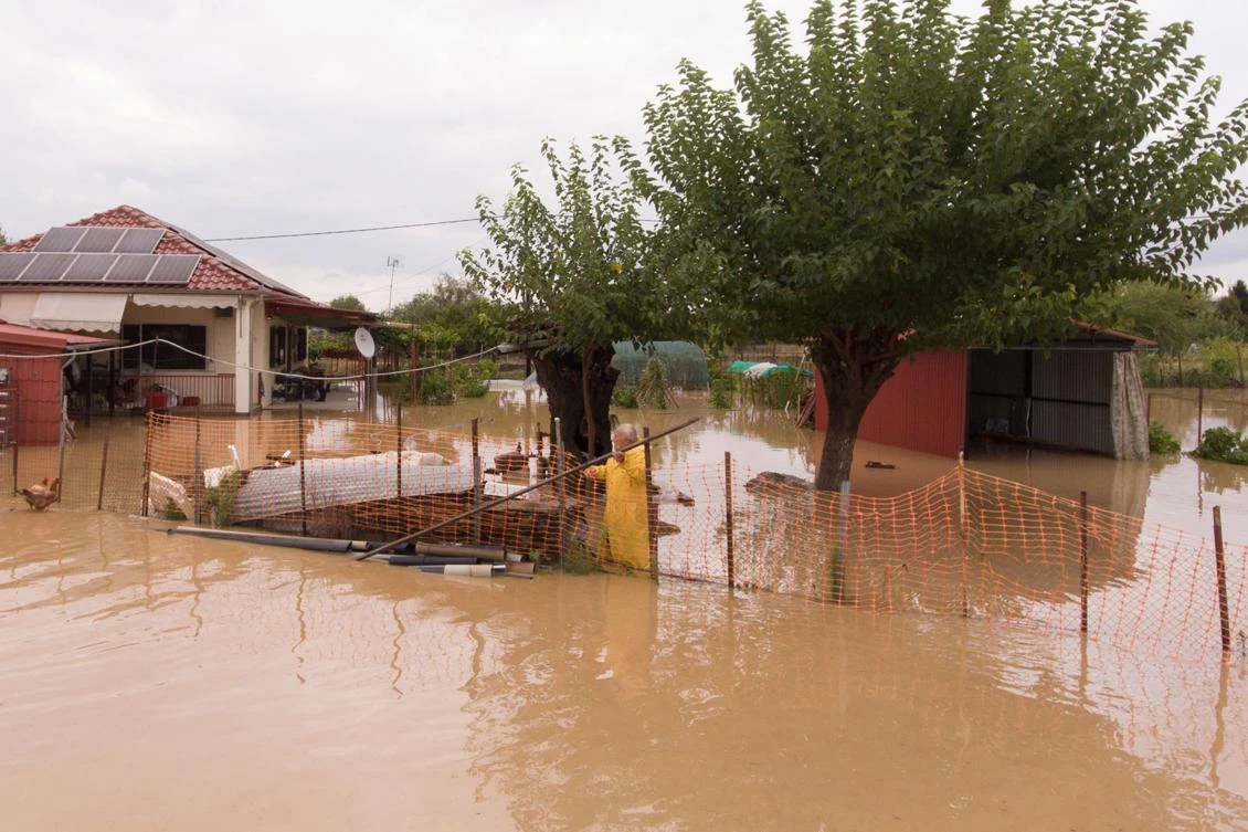 A local is seen in the yard of his flooded house following a storm near the village of Artesiano, in central Greece, September 19, 2020. Picture taken with a drone. REUTERS/Giannis Floulis